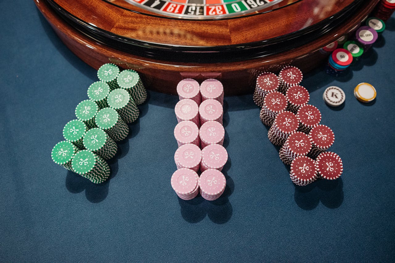 An overhead view of a roulette table with neatly stacked colorful poker chips, reflecting a casino vibe.